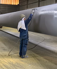 Man coating big metal element